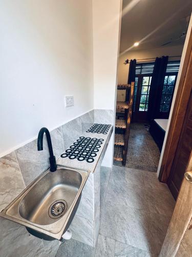 a kitchen with a sink and a stove at Cheff Hotel Vianuel in Kendwa