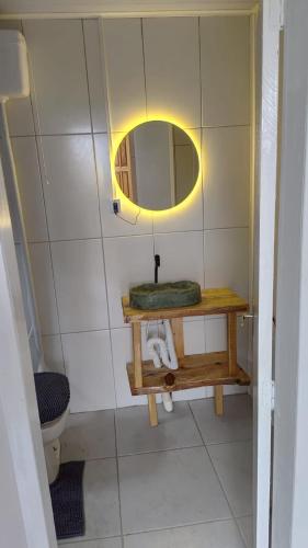 a bathroom with a sink and a mirror on the wall at Casa de Campo Bella Vista in Urupema