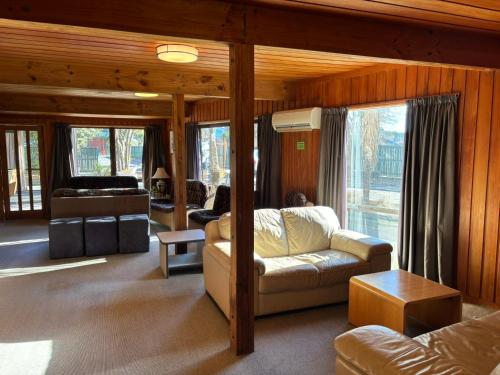 a living room with a couch and a table at Cedar Chalets and Barkers Lodge in Methven