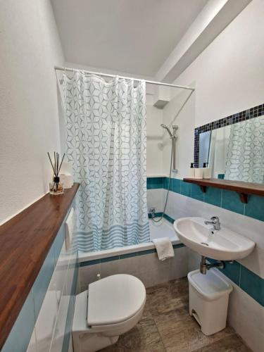 a bathroom with a toilet and a sink at Casa del Sole Guest Rooms in Alghero