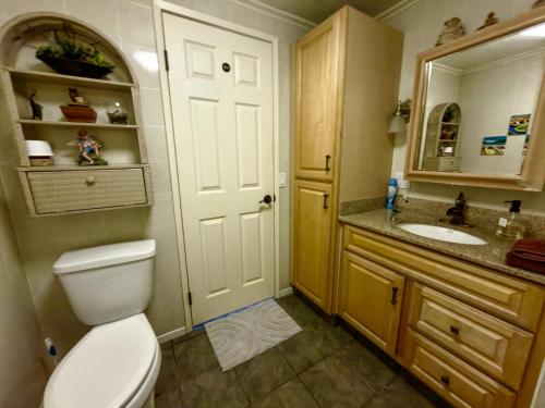 a bathroom with a toilet and a sink and a mirror at Naya homes: The estero beach. in Ensenada