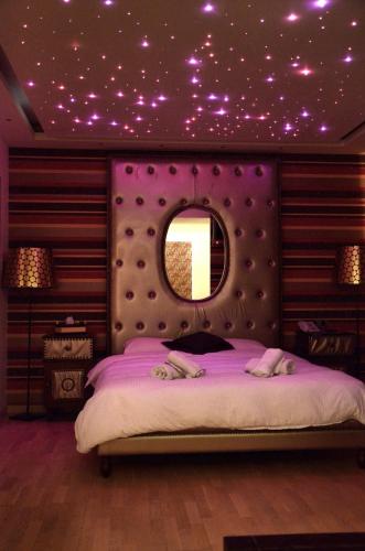 a bedroom with a bed with a purple ceiling with stars at Comfy Boutique Hotel in Kalamata