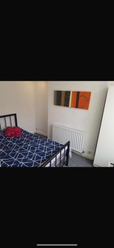 a bedroom with a bed and a painting on the wall at Central stay in Nottingham