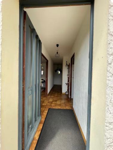 a hallway with an open door to a room at Maison rurale 8 personnes in Saint-Hilaire-de-Court