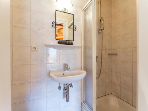 a bathroom with a sink and a shower at Grünbichel Hof I in Uttendorf