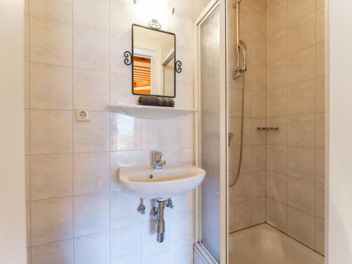 a bathroom with a sink and a shower at Grünbichel Hof II in Uttendorf
