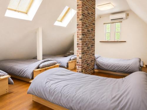 a room with three beds in it with skylights at しまなみ海道-愛犬と泊まれる一棟貸し-本格バレルサウナ-ドッグラン-BBQ完備-YOSHIUMi in Imabari