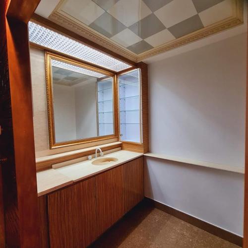 a bathroom with a sink and a mirror at Paradise Pacifica in Pacific Harbour