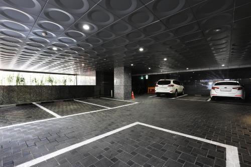 a parking garage with two cars parked in it at Bucheon SR Hotel in Bucheon