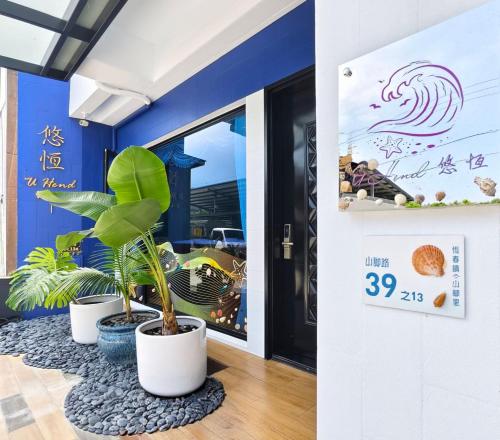 a room with three potted plants in front of a door at u hend villa in Hengchun South Gate