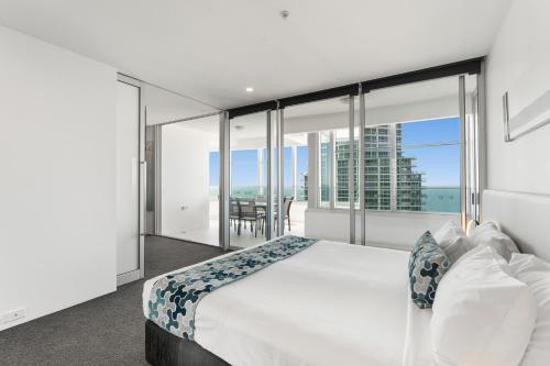 a bedroom with a large bed with a view of the ocean at Q1 Resort & Spa - Official in Gold Coast