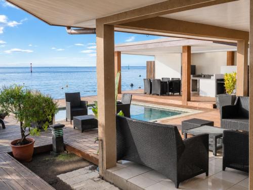 an outdoor patio with a view of the ocean at Villa Manatini in Papeete