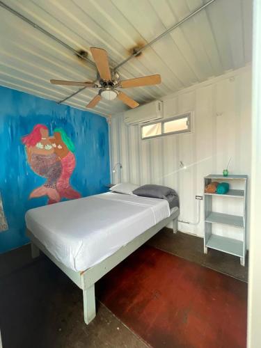 a bedroom with a bed with a ceiling fan at Peace Hostel MX in La Paz