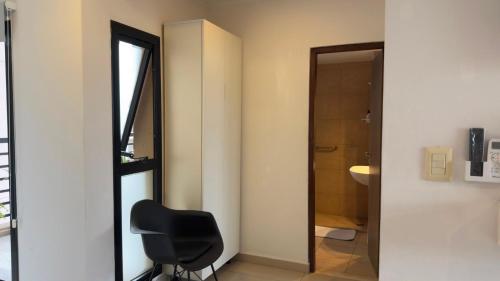 a black chair in a bathroom with a mirror at "REFUGIO EN LA TERRAZA" - WiFi 300mbs in Santiago del Estero
