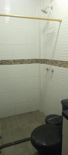 a bathroom with two toilets and a shower at Los Ceibos Hostal in Montecristi