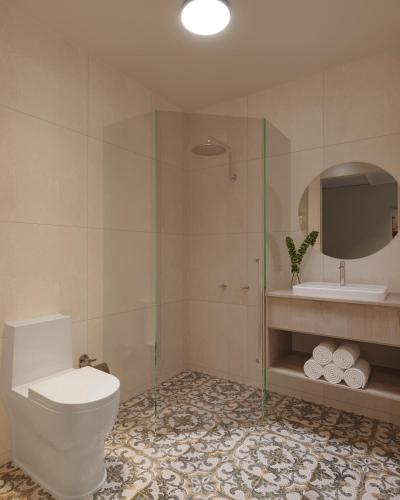 a bathroom with a toilet and a shower and a sink at Nightcap at Esplanade Hotel in Brighton