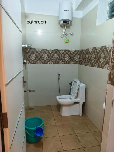 a bathroom with a toilet and a camera on the wall at The single room for two in Madikeri