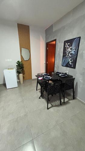 a dining room with a table and two chairs at Apto 05 - A&N Estadia Premium - Centro Bandeirantes PR in Bandeirantes