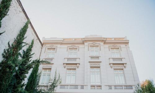 a large white building with windows on the side of it at Matildas Hotel Boutique in Santiago