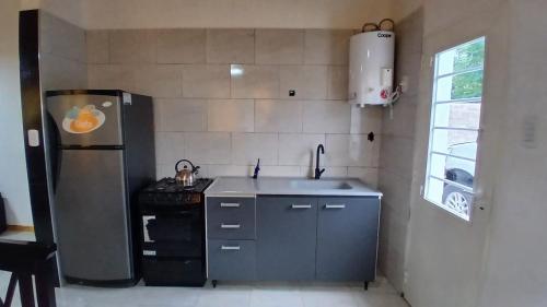 a kitchen with a sink and a refrigerator at La Reina in San Rafael