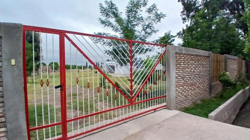 a red gate with a fence in a yard at La Reina in San Rafael
