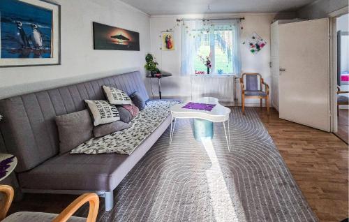 a living room with a couch and a table at Pet Friendly Home In Söderköping in Söderköping