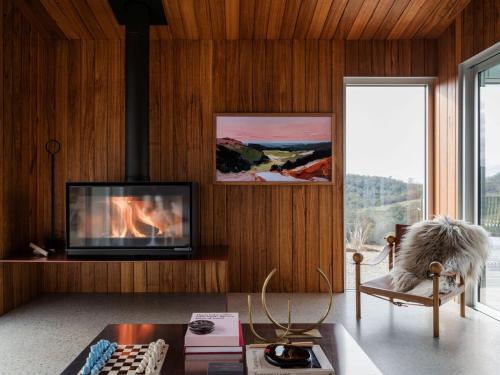 a living room with a fireplace and a tv at Threefold in Swansea