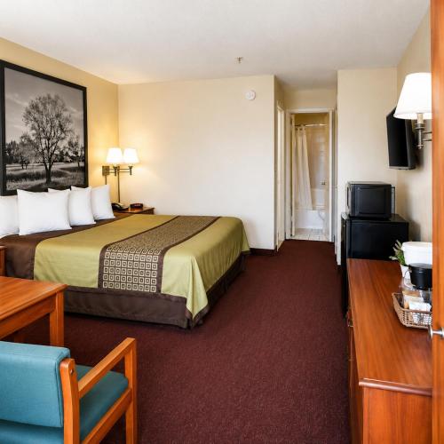 a hotel room with a bed and a television at TrueStay Inn in Bakersfield