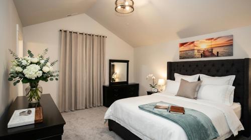 a bedroom with a large bed and a vase of flowers at Kwem Homes in Salem