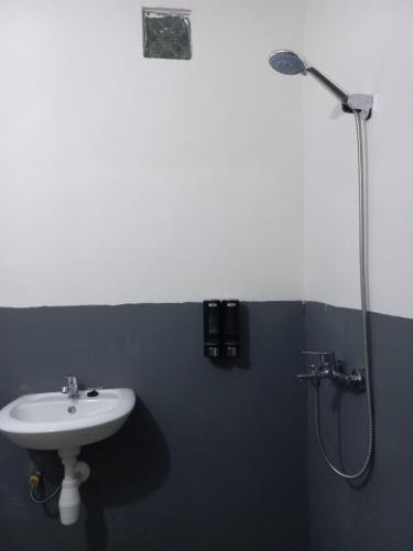 a bathroom with a sink and a shower at Ruteng Glamping & Campsite in Ruteng