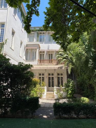 a large white house with a porch and a balcony at Matildas Hotel Boutique in Santiago