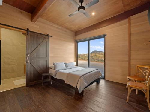 a bedroom with a bed and a sliding glass door at Ridge Way Views in Mansfield
