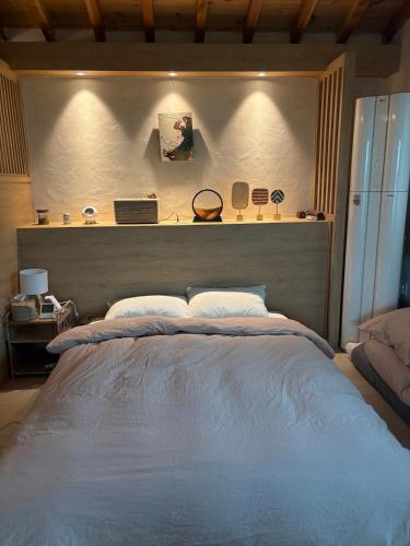 a bedroom with a large bed with a head board at 시골마을 한옥독채 '가니재' in Ssangjŏng-ni