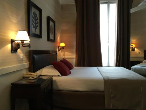 a bedroom with a large bed and a window at Elysées Union in Paris