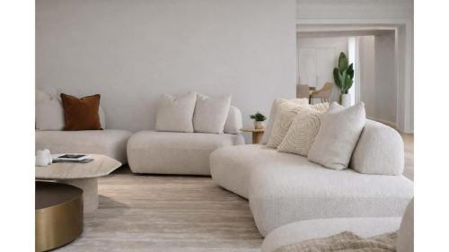a living room with a couch and a table at Balmoral Jetty Estate in Balmoral