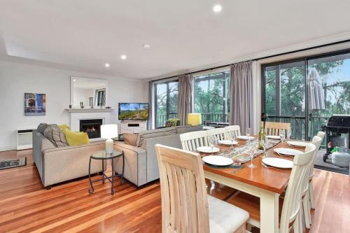 a living room with a table and a couch at Villa 3br Chianti Villa located within Cypress Lakes Resort in Pokolbin