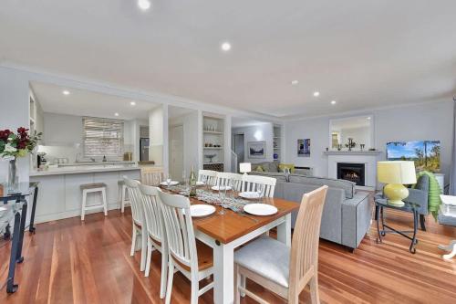 a kitchen and living room with a table and a couch at Villa 3br Chianti Villa located within Cypress Lakes Resort in Pokolbin