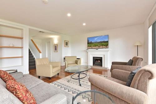 a living room with a couch and a fireplace at Villa 3br Malbec Villa located within Cypress Lakes Resort in Pokolbin