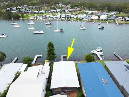 an aerial view of a harbor with boats in the water at Balmoral Waterfront Escape at Lake Macquarie in Balmoral