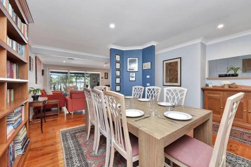a dining room and living room with a table and chairs at Wangi Dreaming in Wangi Wangi