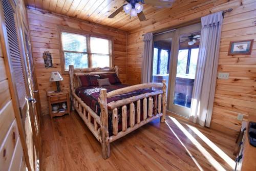 a bedroom with a bed in a log cabin at 4BR/3BA | Hot Tub | Pool Table | Views | Pets ok in Blue Ridge