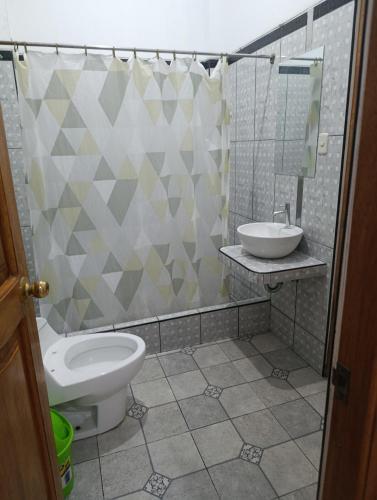 a bathroom with a toilet and a sink at Housing in Mancora in Máncora