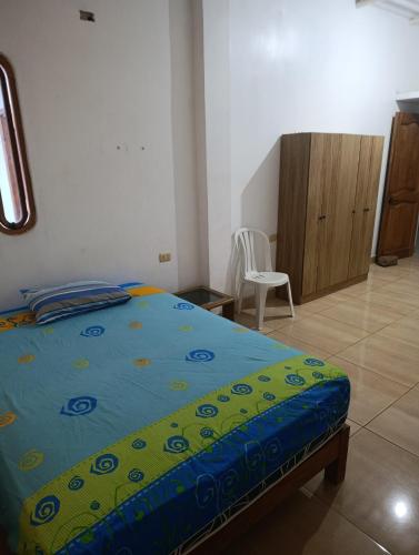 a bedroom with a bed and a desk and a chair at Housing in Mancora in Máncora