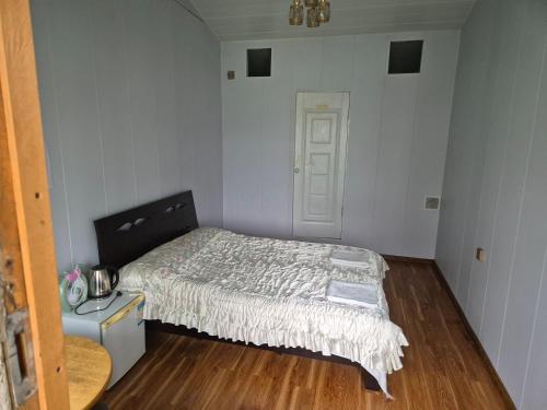 a small bedroom with a bed and a table at Gana's Guest House and Tours in Ulaanbaatar