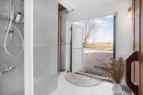 an open door to a bathroom with a shower at 3331-Stege-Raby-Sovej-1 in Stege