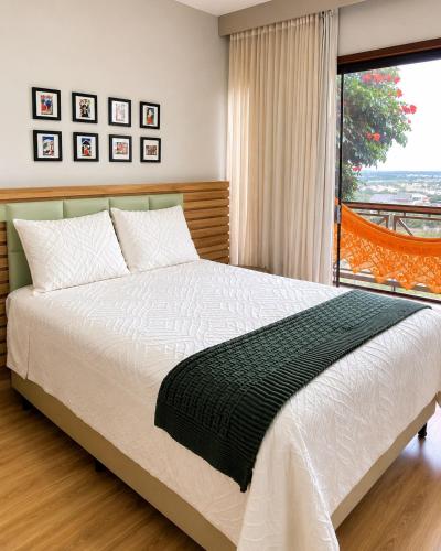 a bedroom with a bed and a large window at Luxury flat in Monte Castelo in Sairé