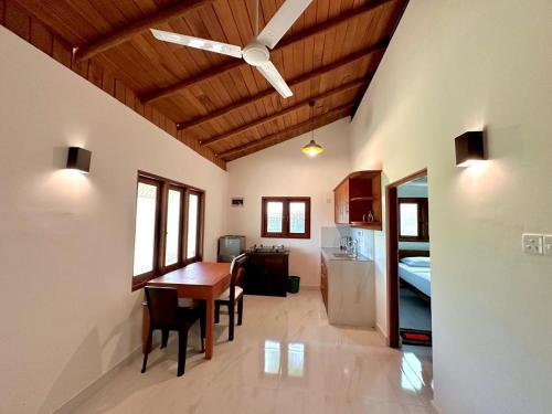 a kitchen and dining room with a ceiling fan at Body,Mind & Soul in Bentota