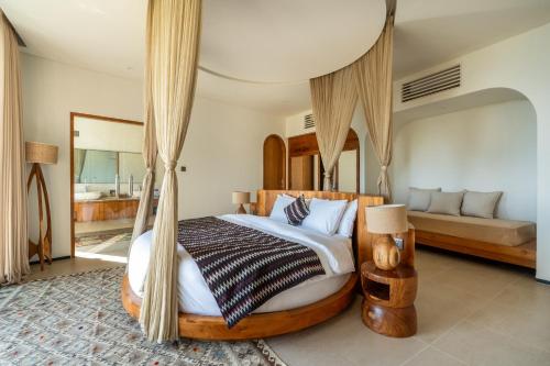 a bedroom with a bed with a canopy at Villa Karilla in Toyapakeh