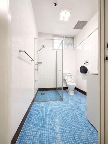 a bathroom with a shower and a toilet at Box Hill Student Accommodation and Rooming House in Box Hill