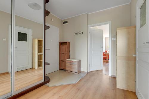 a large mirror in a room with a closet at Słoneczny Widok in Gdynia
